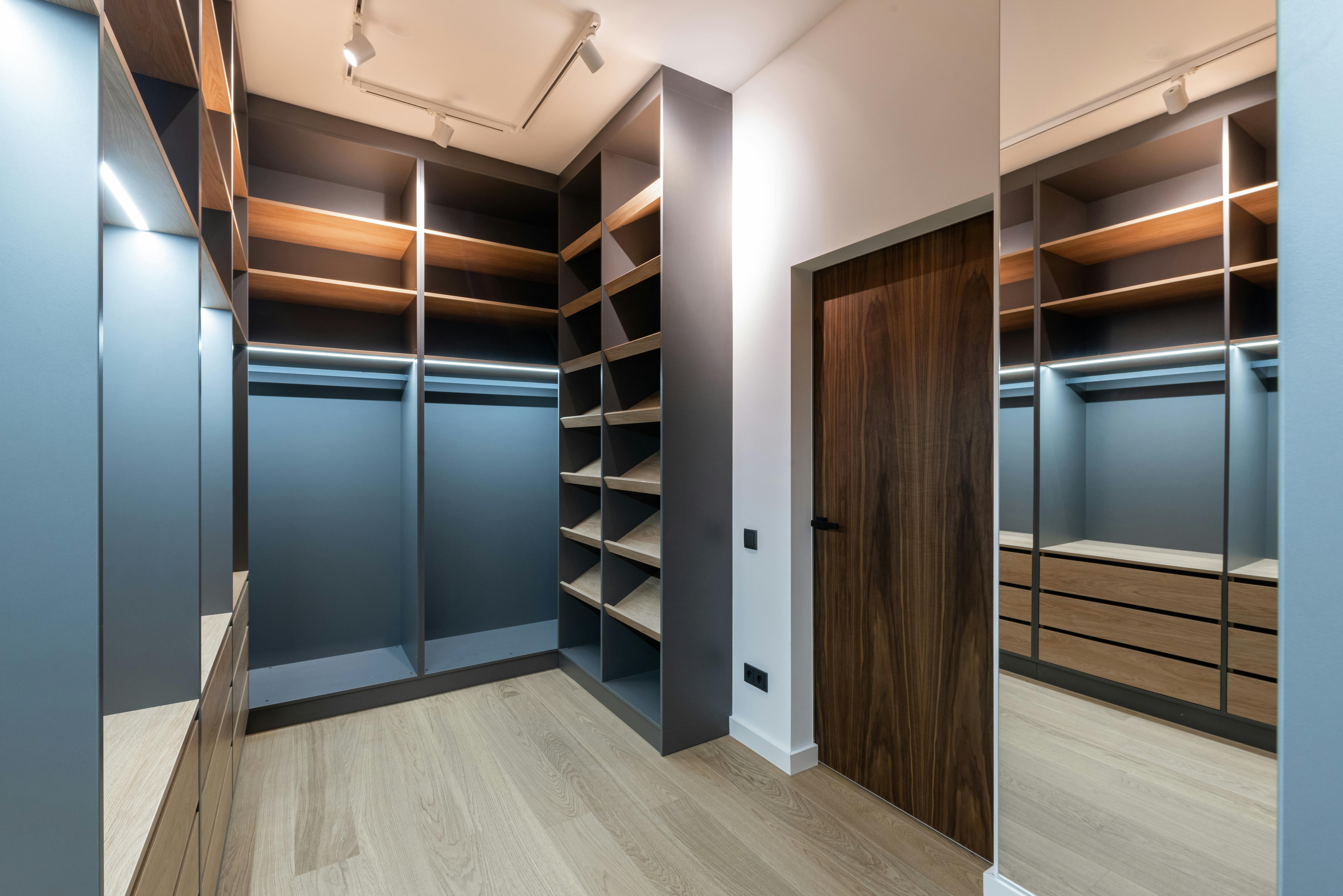 A room with a wooden floor and a brown door.